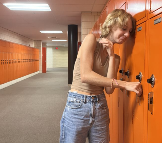 Distressed+freshman+tries+endlessly+to+open+the+locker%2C+losing+faith+in+all+humanity.+Photo+taken+by+Arianna+Hernandez+