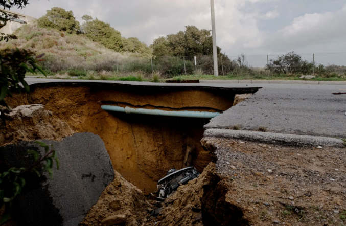 Pictured above is a sinkhole which has appeared after the severe flood rains in Los Angeles. Photo Courtesy of The New York Times.