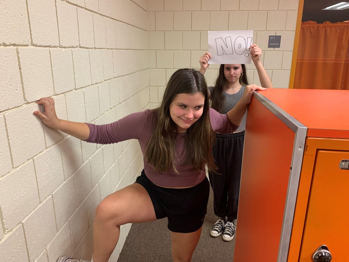  

Pictured are students Senior Megan Watts and Freshman Maggie Watts. Maggie Watts is seen breaking rules and is being advised against it by her Senior counterpart. Photo courtesy of Juliana Vendetti
