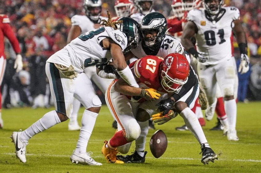 Chiefs+tight+end+Travis+Kelce+drops+the+ball+while+being+tackled+by+two+of+Philadelphia+Eagles%E2%80%99+defensive+players.+Photo+courtesy+of+Sports+Illustrated.