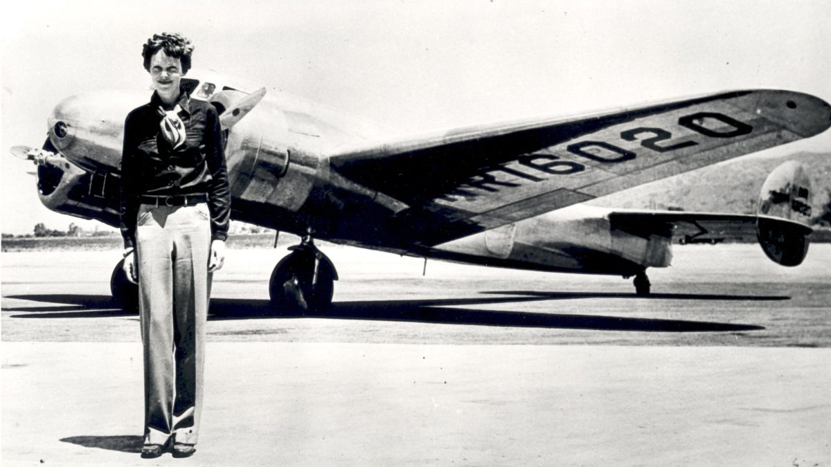Earhart standing with her aircraft before takeoff. Photo courtesy of SSPL/Getty Images.