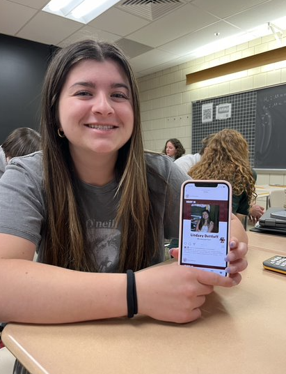 Senior Lindsey Dettloff posing with her post on the Boston College 2028 page. Photo courtesy of Grace Daly.