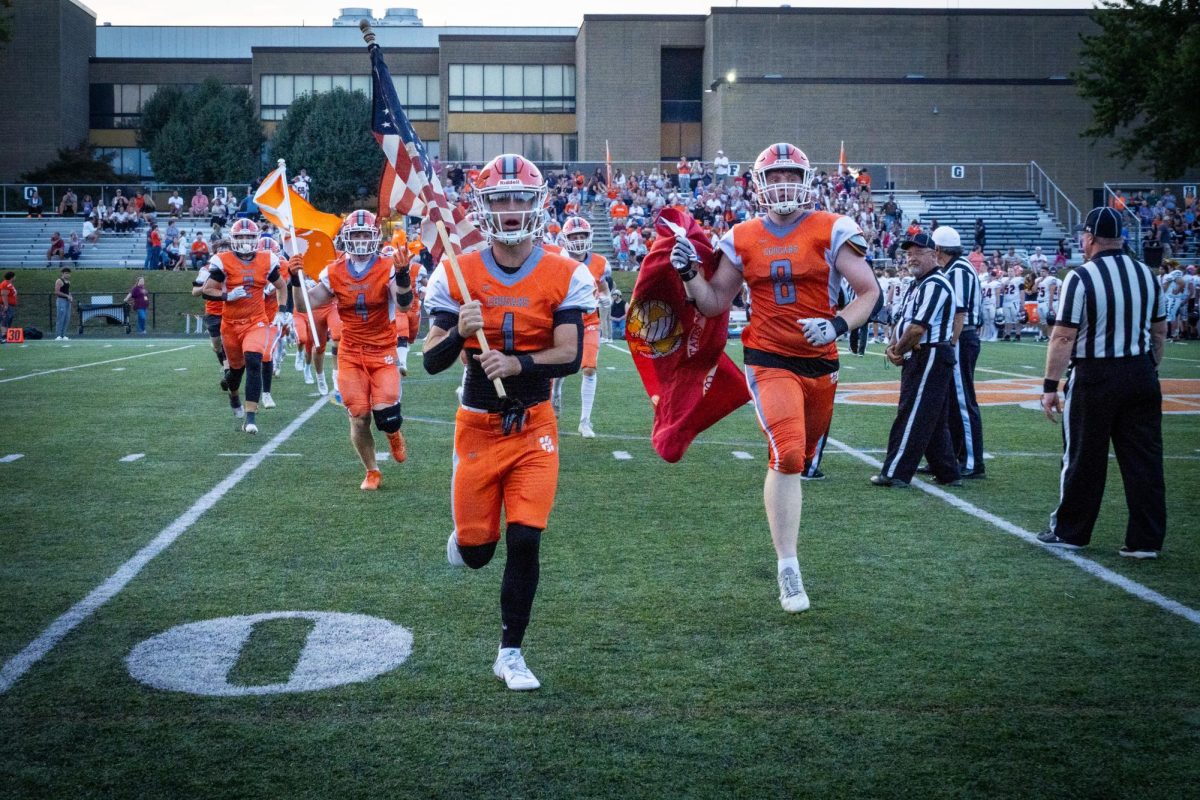  Captains (Left to Right) Evan Alcide, Dominic Foster, and Oliver Rueckert carry flags as they lead Fallston’s football team onto the field prior to their 35-8 win against Rising Sun on Friday, September 20th. (Photo Courtesy of Joseph Mullen) 