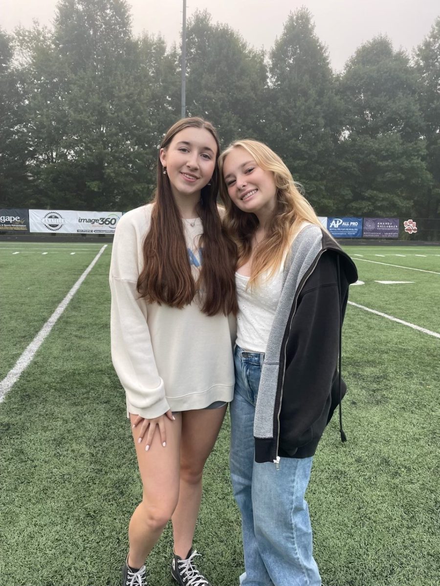 Kaitlyn Hughes (left) and Maddy Warren (right) snap a picture together on the turf. (Photo courtesy of Kaitlyn Hughes)