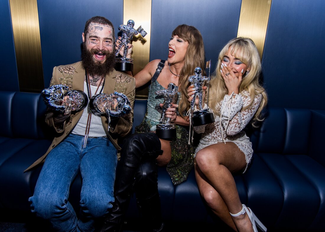 Pictured left to right, Post Malone, Taylor Swift, and Sabrina Carpenter posing with their newly won awards. (Photo courtesy of John Shearer/ Getty images/ MTV)