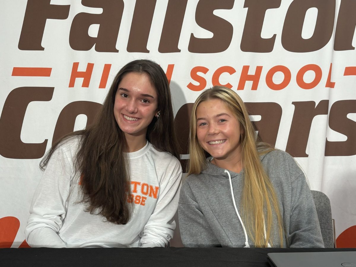 Natalie Wirth (left) and Sarah Farally (right) posing before their announcements for the day. (Photo courtesy of Madi Hoyer)