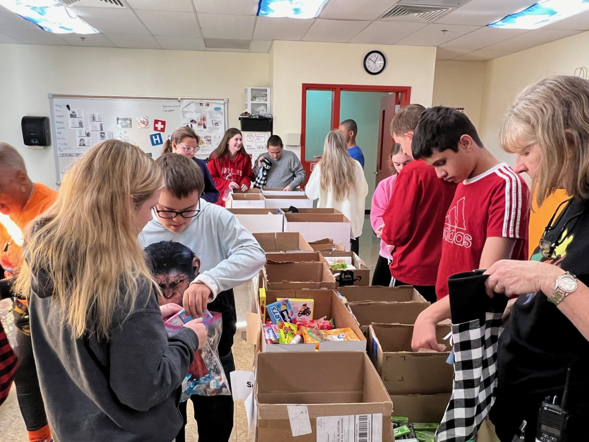 Best Buddies work with STRIVE and staff to assist in the stocking stuffing process.  Photo Courtesy of Ms. Trexler.