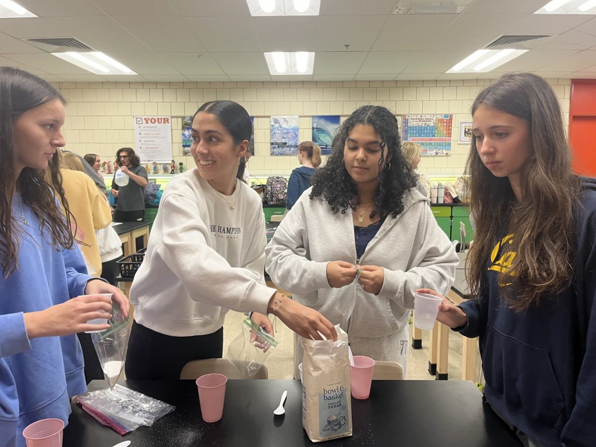 Pictured left to right: Careina, Mankirat, Ginna, and Amelia happily concoct their ice cream formula while also socializing with fellow Science NHS members. Photo courtesy of Maddy Burch.