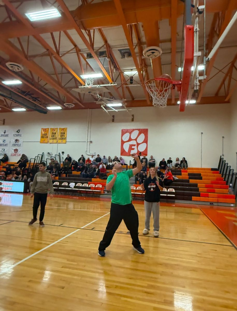 Ryan Jarusewic shows off his basketball skills at halftime alongside Sarah Gent. Photo Courtesy of Elizabeth Bromley.