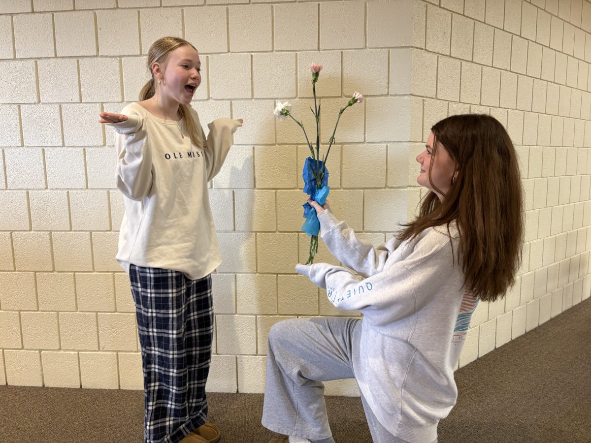 Auggie McCarthy asks Sydney Dougherty to be her Valentine with some beautiful carnations. Photo Courtesy of Louis Liu.