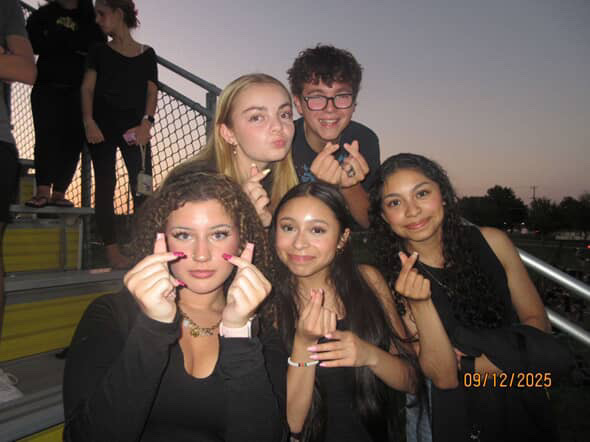 Clad in matching black attire, a group of students show their school spirit during a blackout themed football game, their enthusiasm shining through. Top row from left to right: Maggie Hartline and Ben Montoya Bottom Row left to right: Hazel Kazi, Kelly Ramos, Angelina Ramos. Photo courtesy of Maggie Hartline.