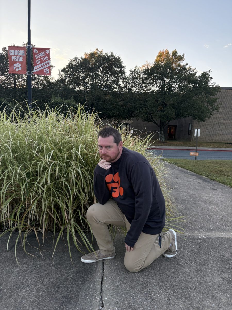 Mr. Childs posed in front of the school in his Cougar Pride attire very thoughtfully. (Photo courtesy of Louis Liu) 