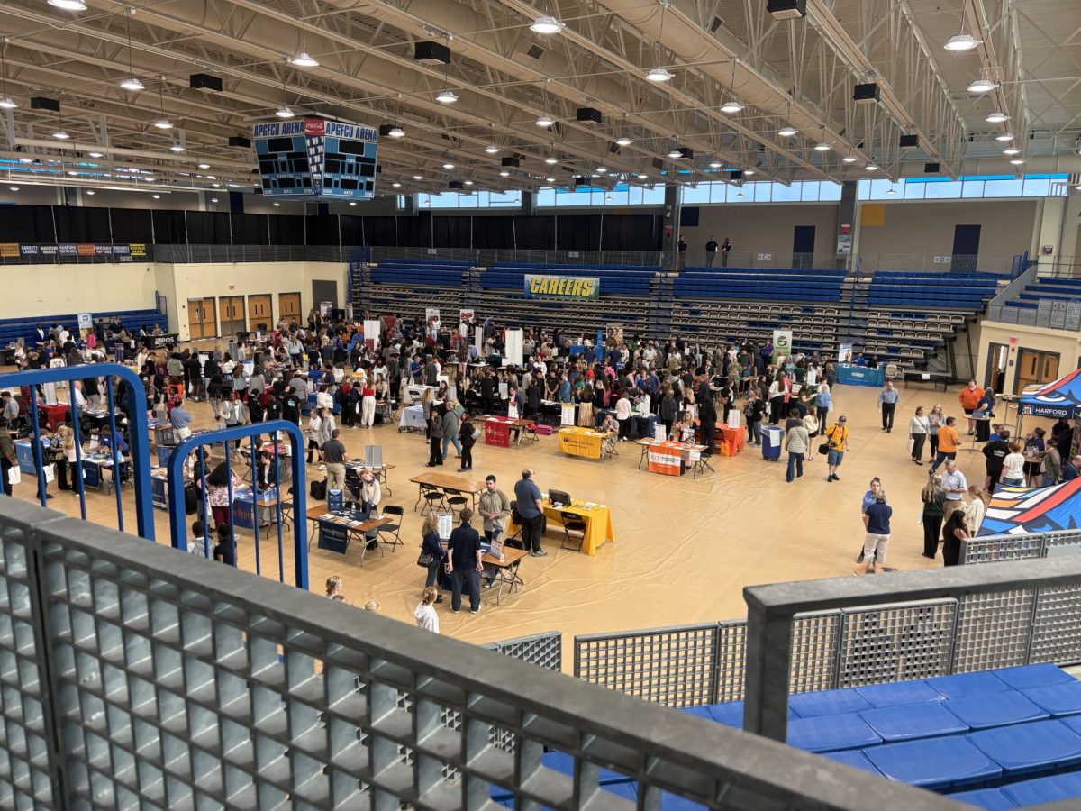 College booths lined with students eager to find out more information from college representatives at the APGFCU Arena. Photo Courtesy of Louis Liu