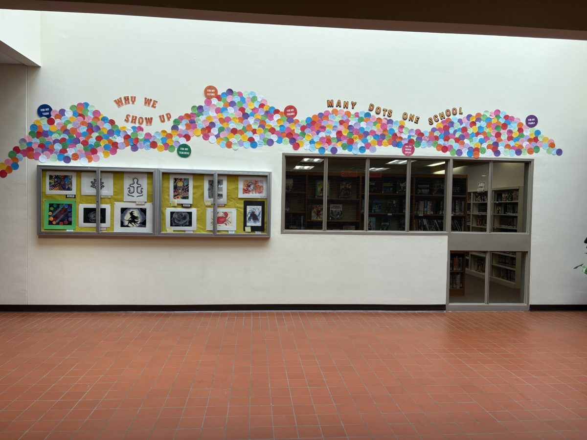 As part of the “Why I Show Up” project, the main hallway is covered with numerous reasons why students show up. Photo courtesy of Louis Liu.