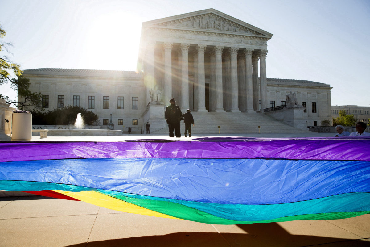 Pride colors wave in front of the pillars of democracy. Photo courtesy of PBS News  