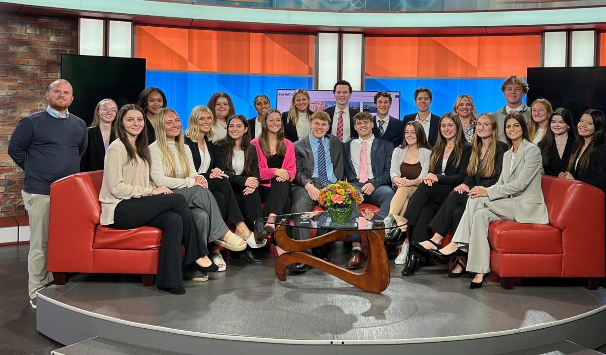 Fallston High School’s senior leadership course poses in the live news room at the WBFF Fox45 facility. The students were preparing to watch the midday news broadcast from this couch. Photo Courtesy of Ashley Canatella. 