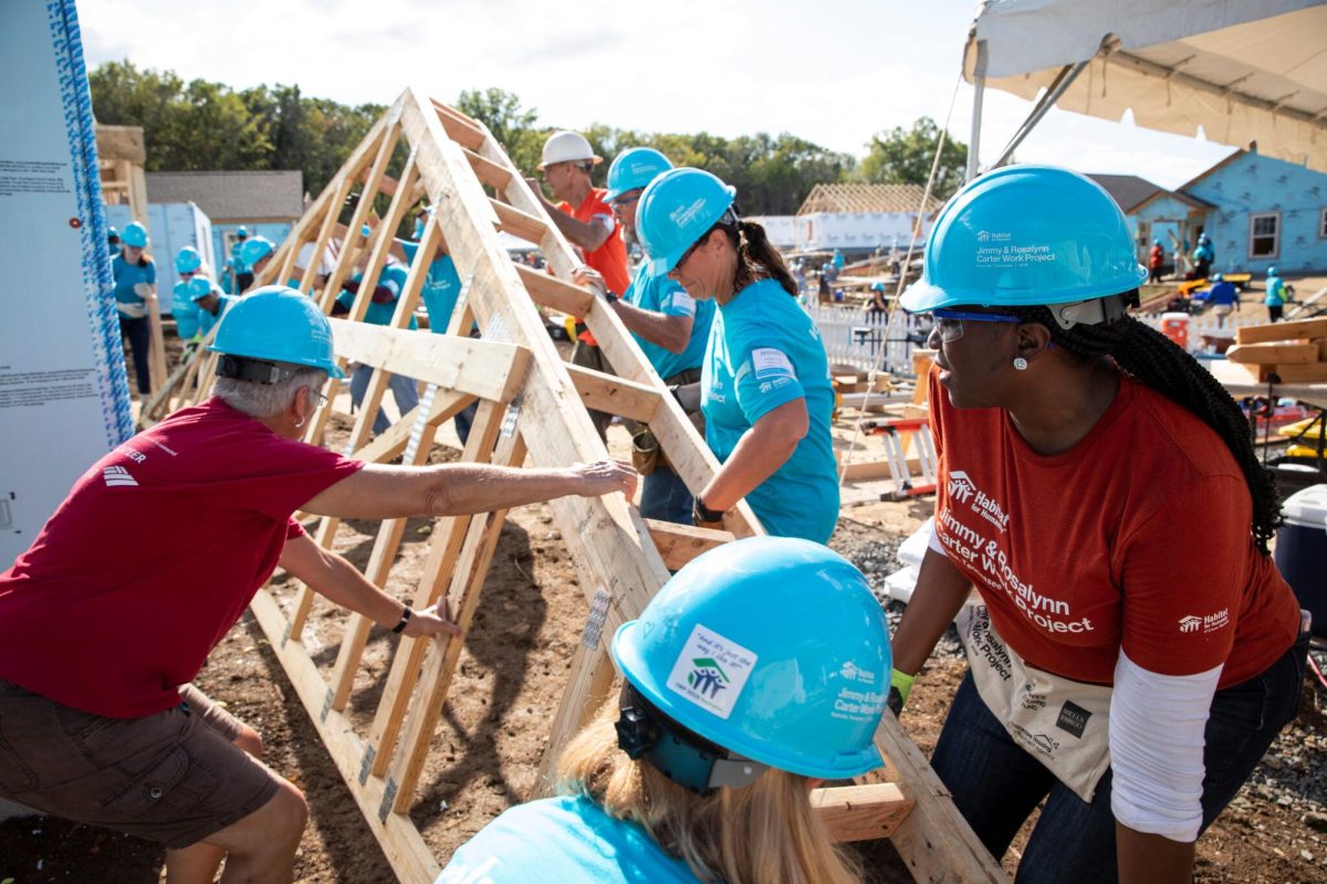 Habitat for Humanity volunteers work together to create and build affordable housing and make a difference in their community. Photo Courtesy of The New York Times