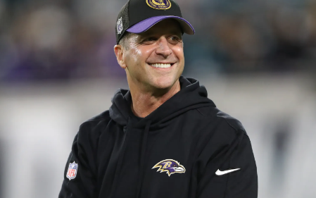 Caption: Coach John Harbaugh reacts to cheering fans before a game against the Jacksonville Jaguars at EverBank Stadium in 2023. Photo Courtesy of Courtney Culbreath/Getty Images 
