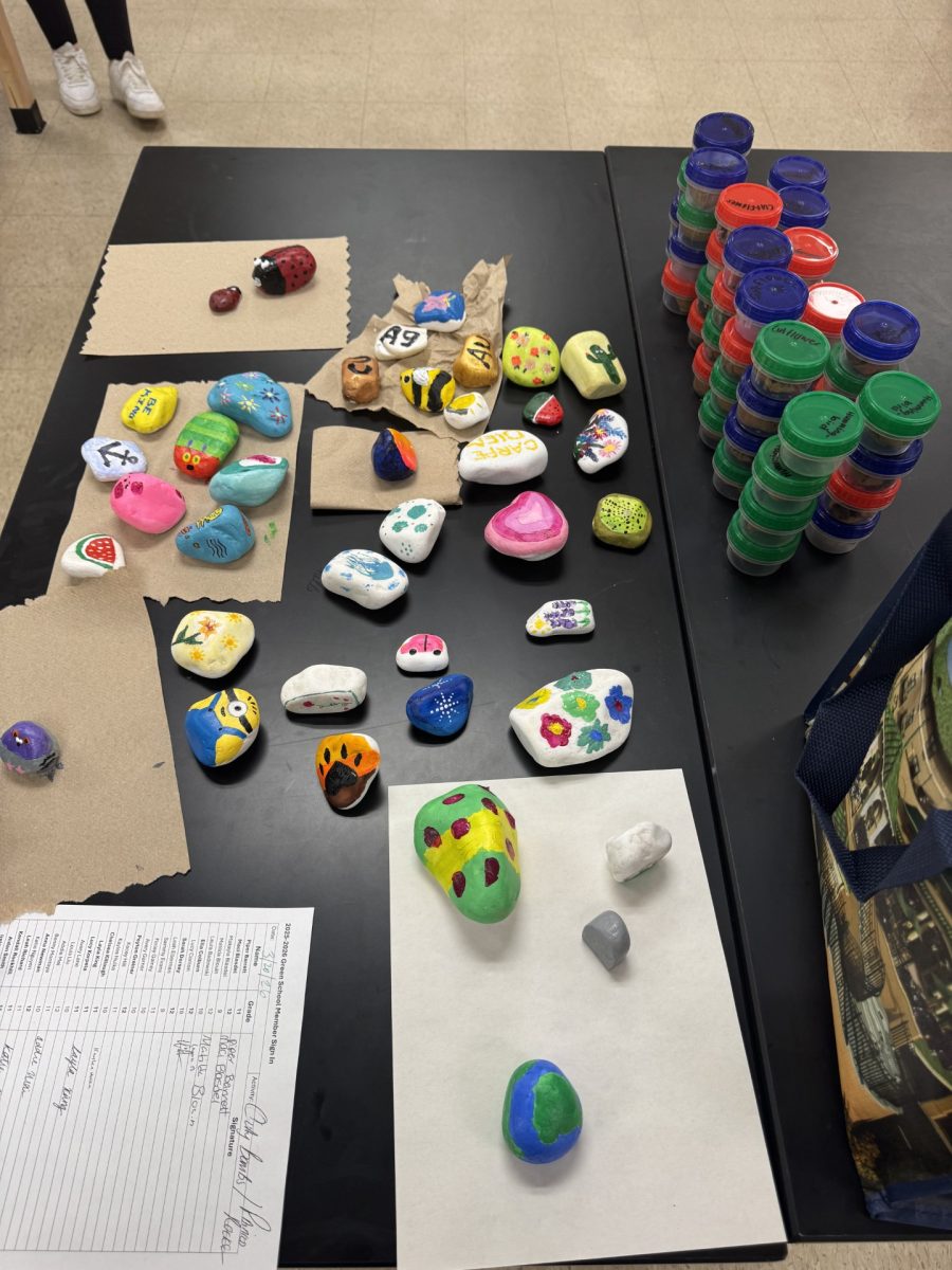 Students and staff hand crafted custom clay-bombs filled with environmentally benefiting flowers; as well as hand painting stones to decorate local gardens. Photo courtesy of El Colburn.
